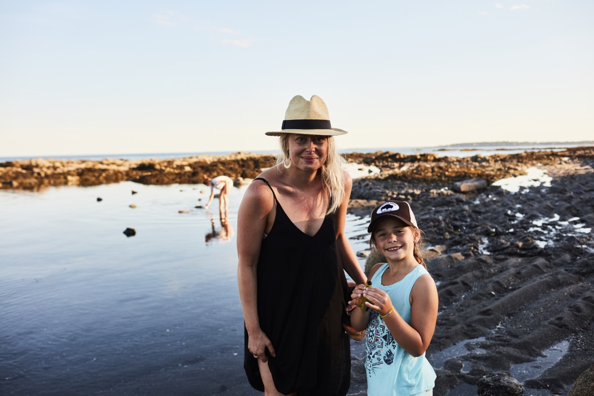 mother and daughter exploring tide pool